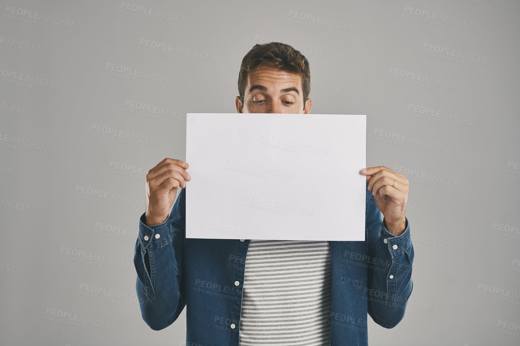 Buy stock photo Man, blank and placard with paper in studio of billboard announcement, presentation and branding logo. Male person, notice and advertising for news poster, signage and notification on gray background