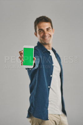 Buy stock photo Portrait, man and phone with green screen in studio for advertising, social media and branding website. Smile, person and mobile for tracking marker, contact announcement and offer on gray background