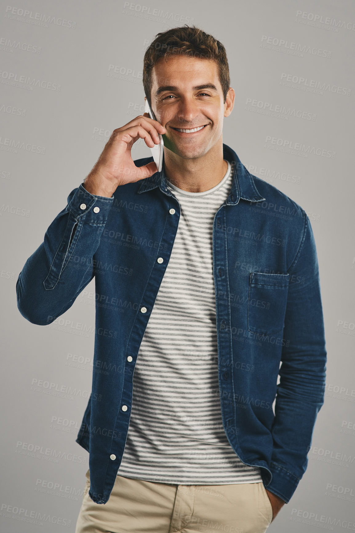 Buy stock photo Studio, man and portrait in phone call with laugh, funny news and comedy with contact. Creative worker, conversation and networking on mobile with humor, chatting and connection by gray background