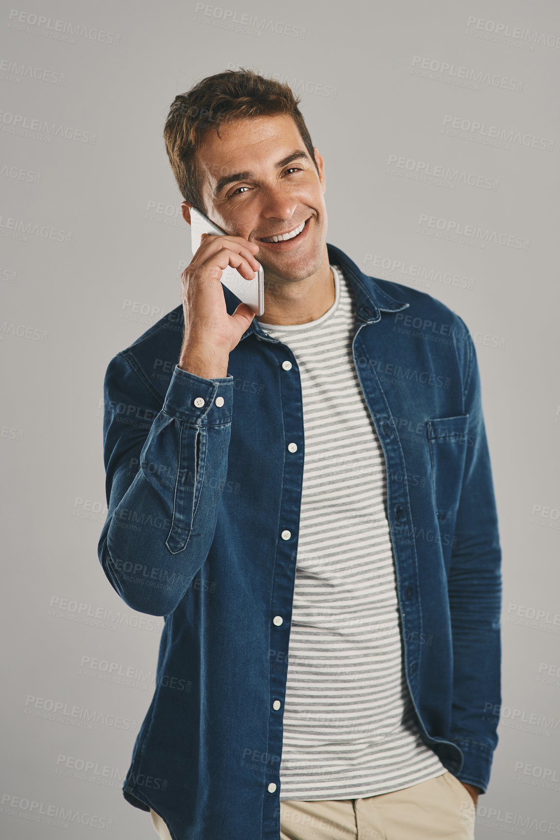 Buy stock photo Studio, man and portrait in phone call with smile, funny news and comedy with contact. Creative worker, conversation and networking on smartphone with humor, chat and connection by white background