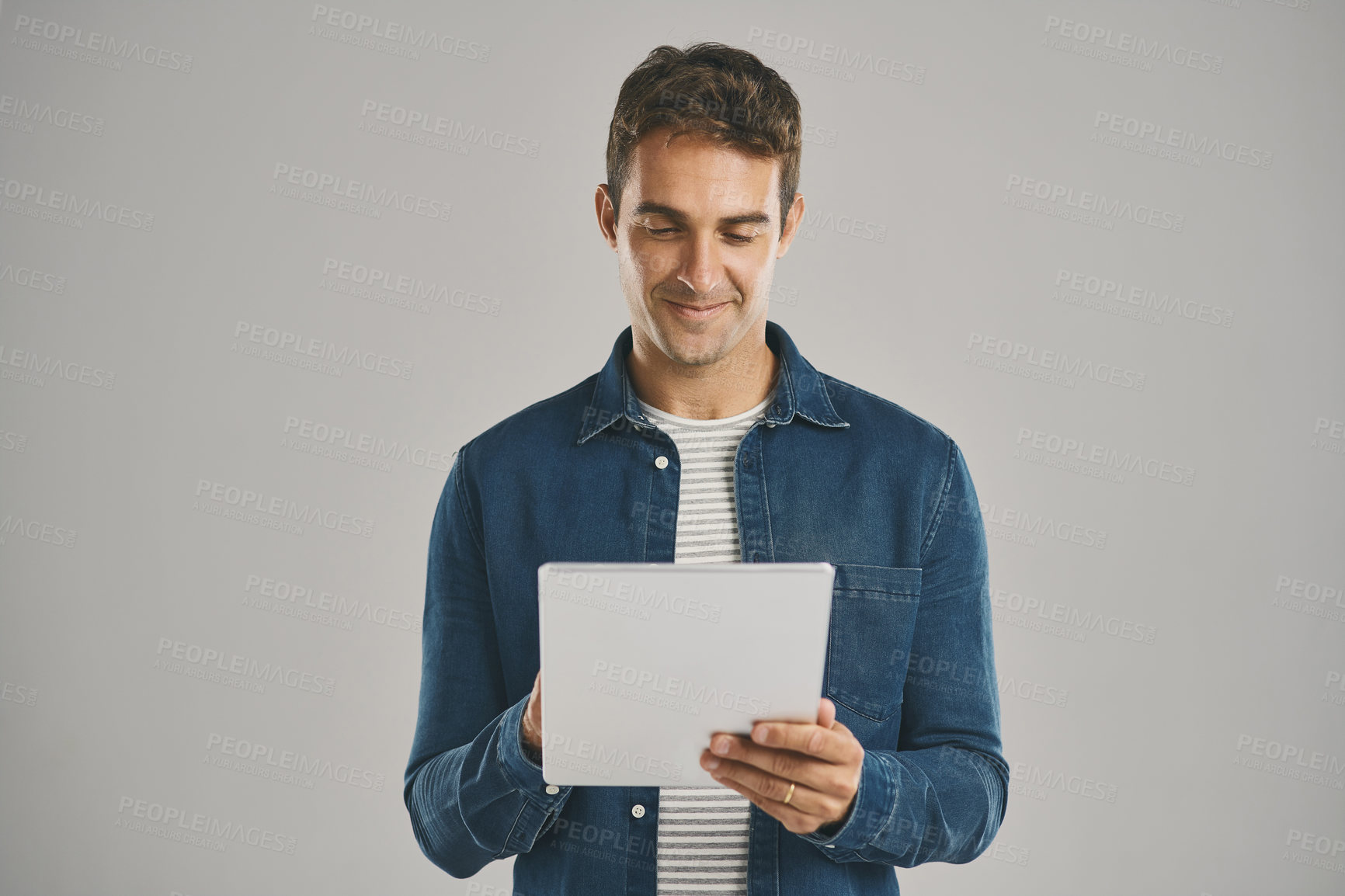 Buy stock photo Ecommerce, smile and tablet with man in studio isolated on gray background for app download or update. Search, social media and website with happy user in casual outfit for online shopping or retail