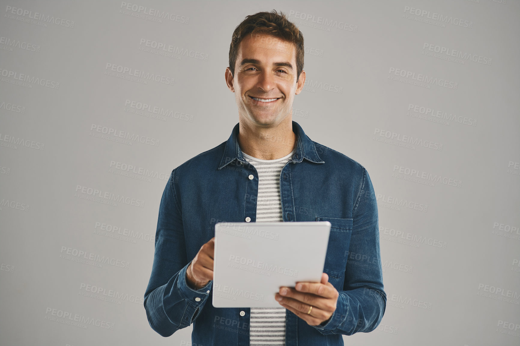 Buy stock photo Portrait, smile and tablet with man in studio isolated on gray background for app download or update. Ecommerce, search and social media with happy user in casual outfit for online shopping or retail