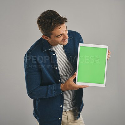 Buy stock photo Green screen, smile and tablet with man in studio isolated on gray background for app download or marketing. Advertising, mockup space and and website with happy user in casual outfit for promotion