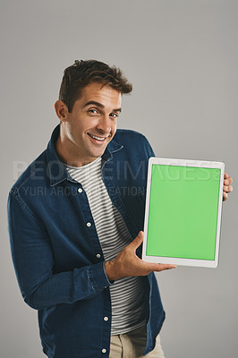 Buy stock photo Green screen, portrait and tablet with man in studio isolated on gray background for advertising or marketing. App, display and smile with happy user in casual outfit for notification or promotion