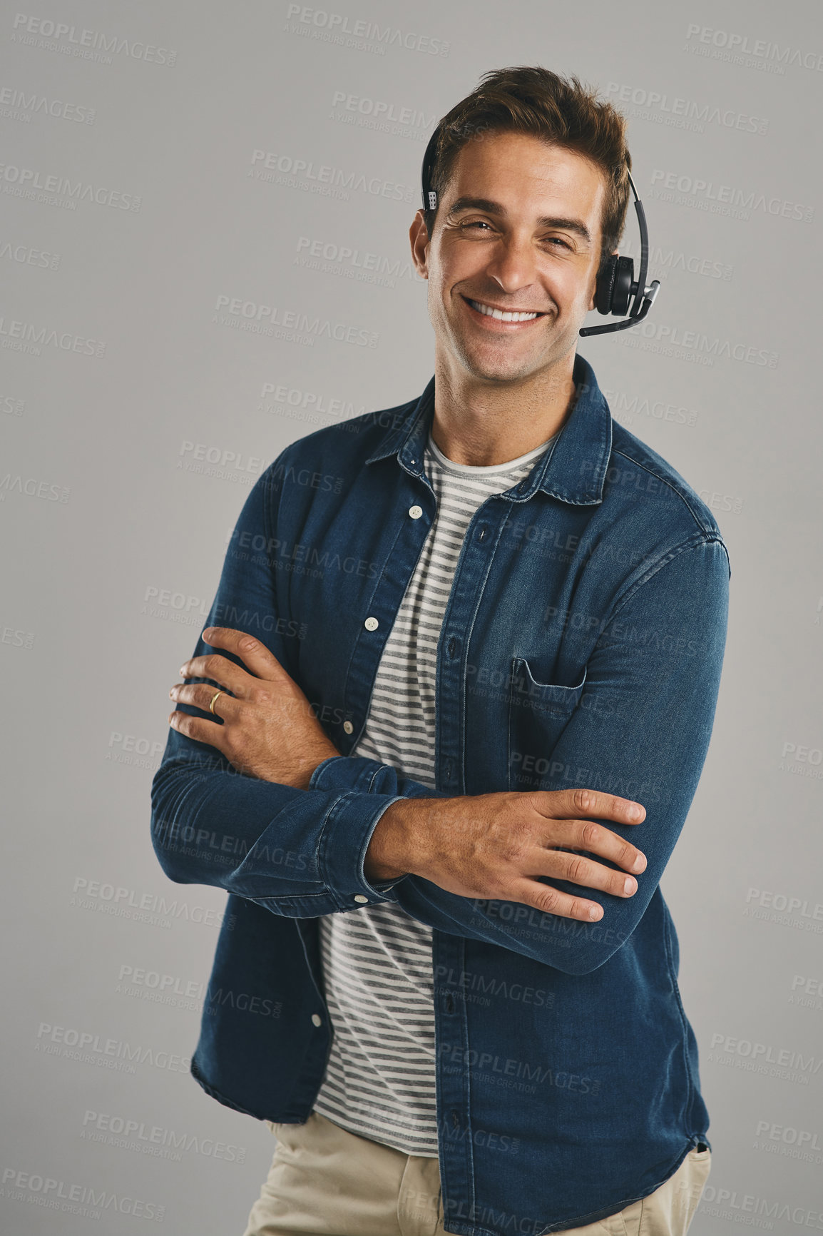 Buy stock photo Call center, man and studio with arms crossed on headset for customer service or advice on white background. Male person, portrait and smile or proud with headphones for telemarketing and consulting