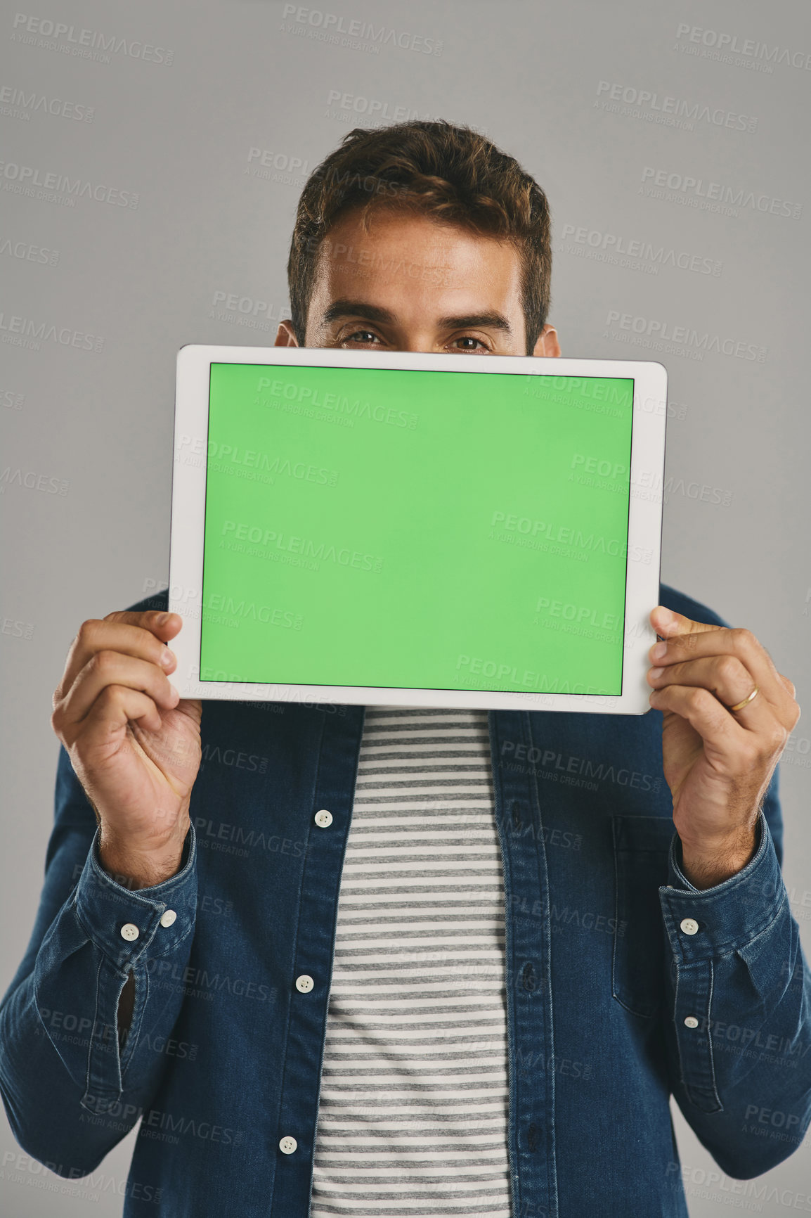 Buy stock photo Eyes, green screen and tablet with man in studio isolated on gray background for app download or update. Portrait, social media and website with happy user in casual outfit for online marketing