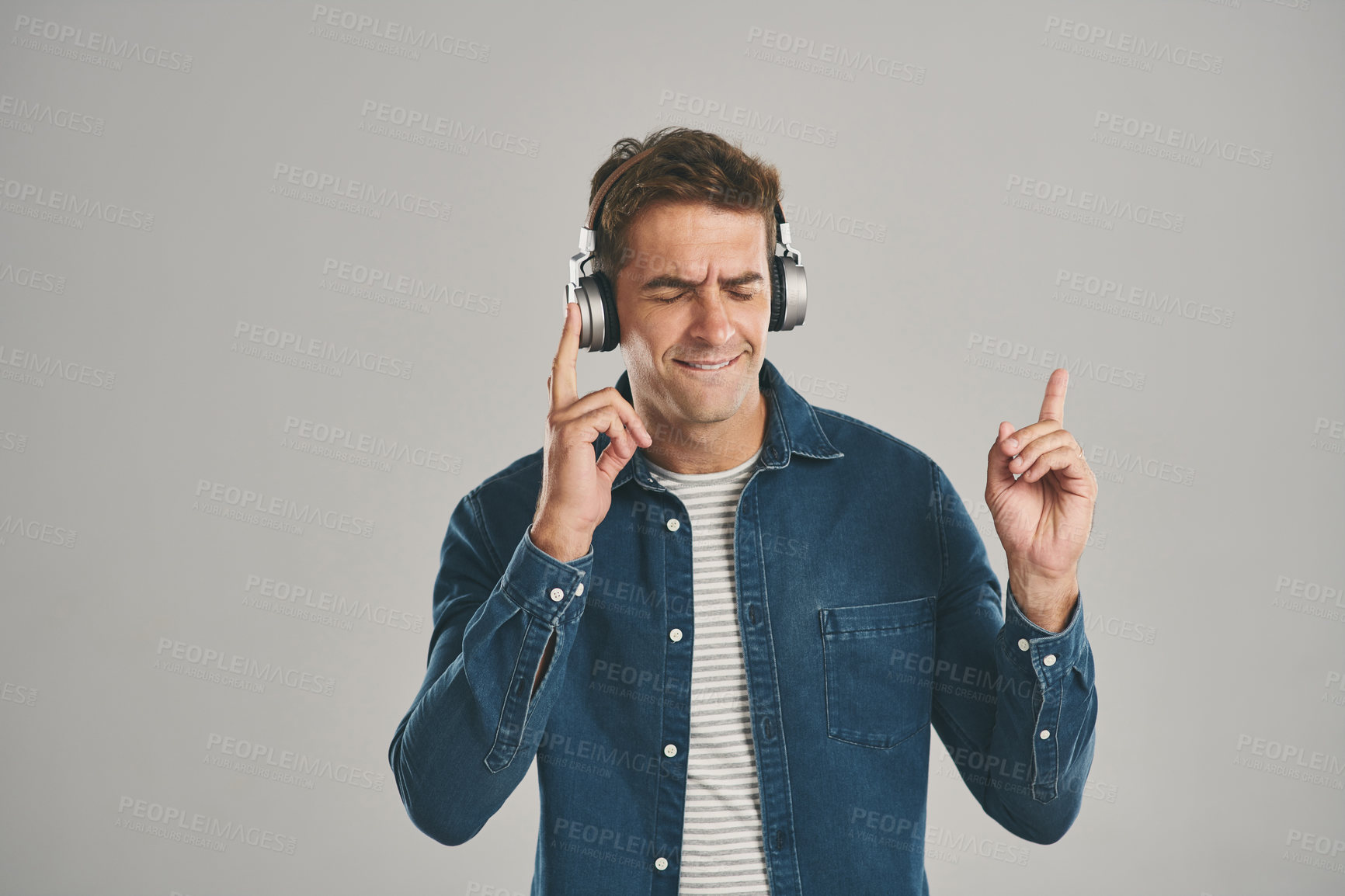 Buy stock photo Listening, music and man with headphones, studio and streaming of song, artist and relax with podcast. Mockup, happy and sound of radio, hearing and audio for person, app and online with subscription