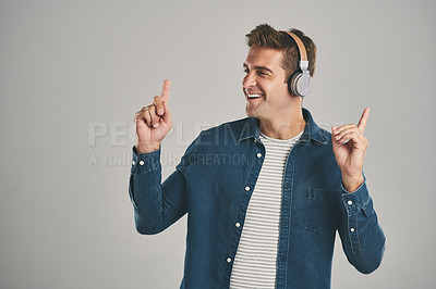 Buy stock photo Dancing, music and man with headphones, studio and streaming of song, artist and relax with podcast. Mockup, happy and sound of radio, hearing and audio for person, app and online with subscription