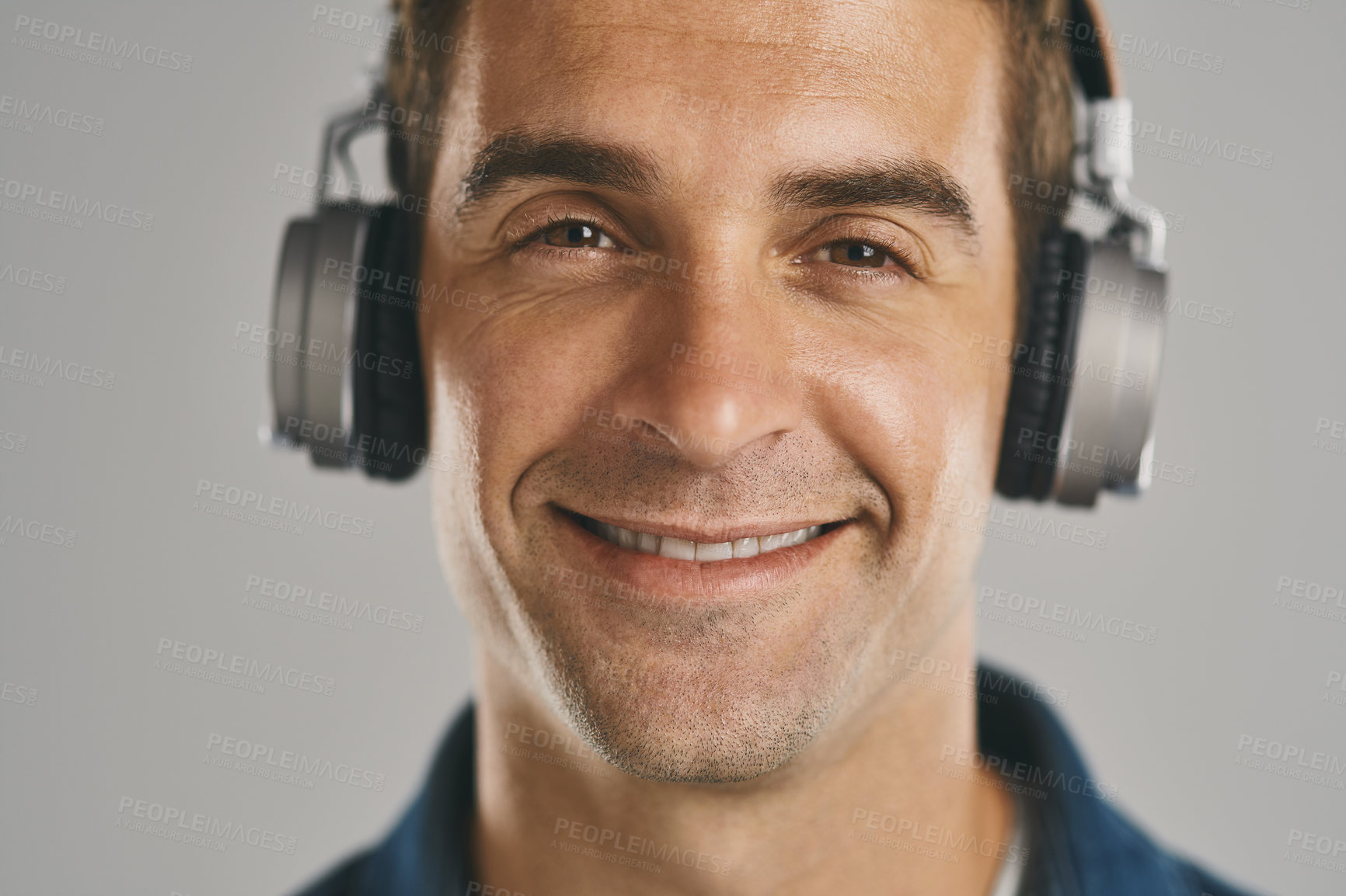 Buy stock photo Portrait, smile and man with headphones, studio and streaming of song, artist and relax with podcast. Listening, happy and sound of radio, hearing and audio for person, app and subscription in Canada