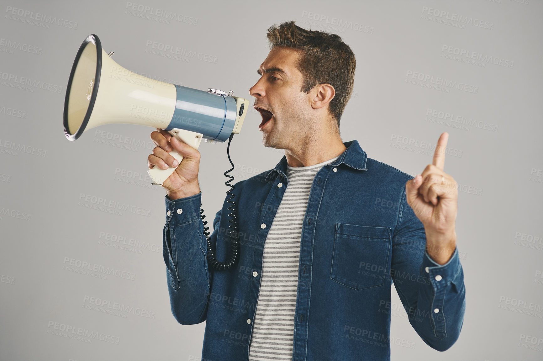 Buy stock photo Man, shout and megaphone for point in studio of communication, community justice and warning protest. Person, microphone and attention with announcement, call to action and opinion on gray background