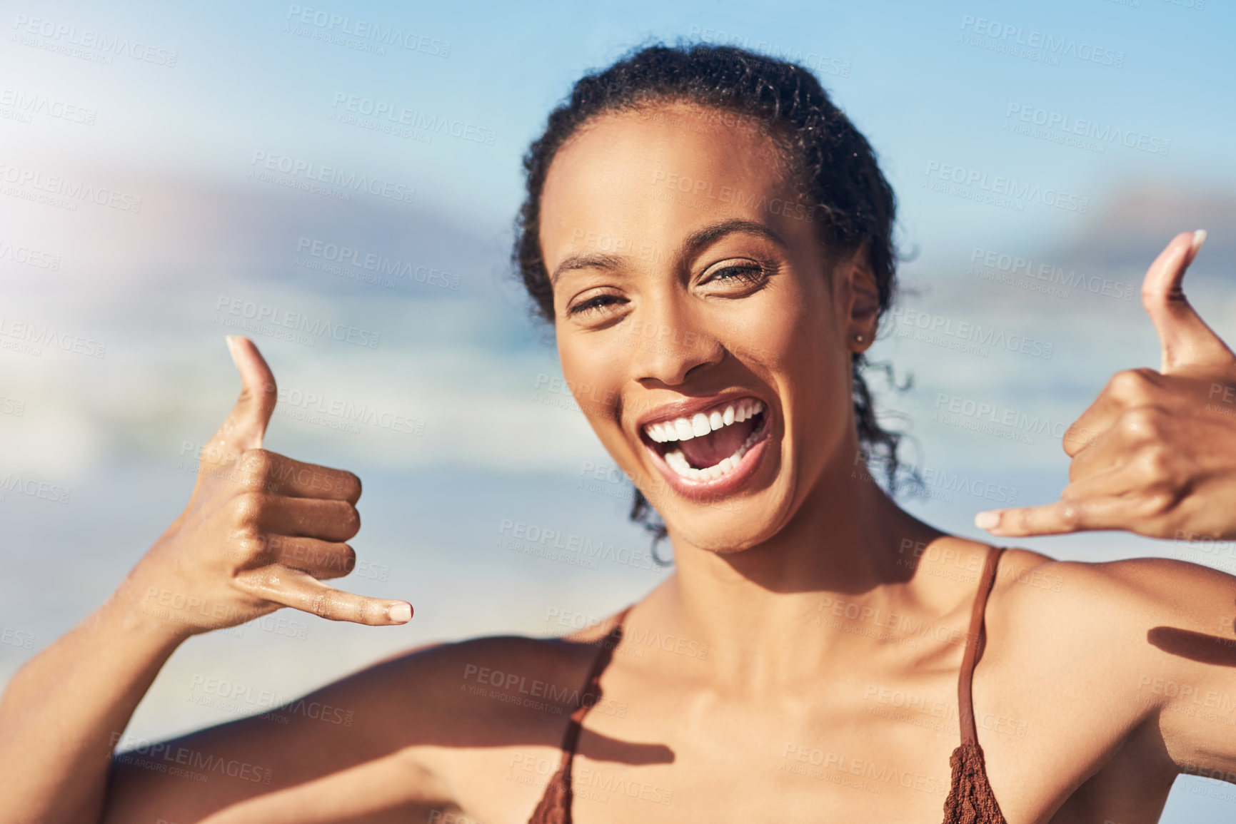 Buy stock photo Woman, portrait and happy at beach for freedom, travel and relax in outdoor on vacation at sea. Female person, shaka sign and holiday in nature by waves, tropical and island adventure to hang loose