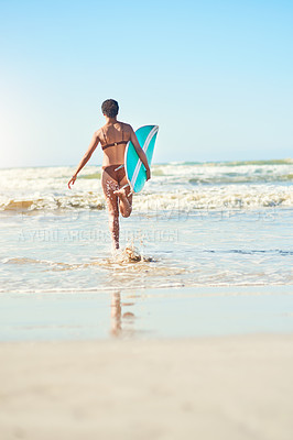 Buy stock photo Shot of a young woman out at the beach with her surfboard