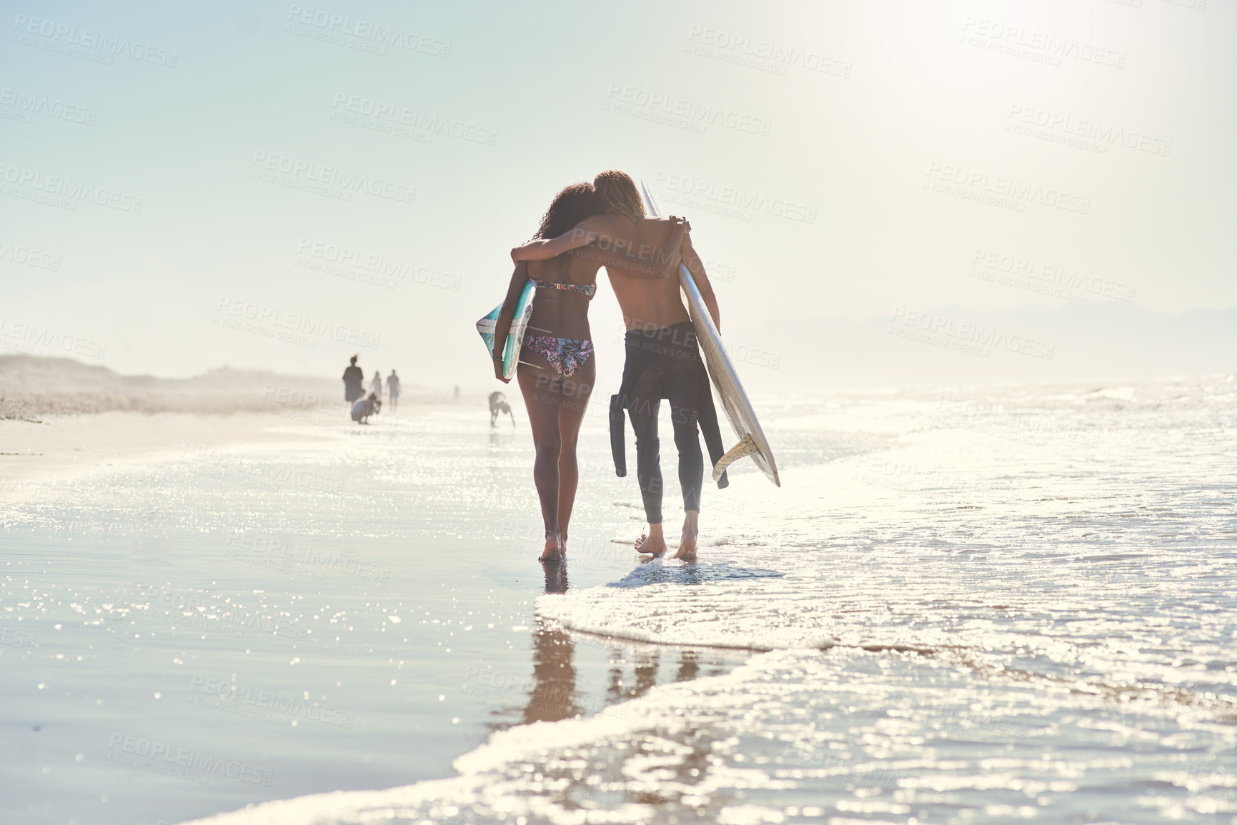 Buy stock photo Love, hug and couple with surfboard at a beach for summer, fun and bonding on vacation in nature. Sunset, back or surfer people embrace while walking at sea for travel, romance or anniversary holiday