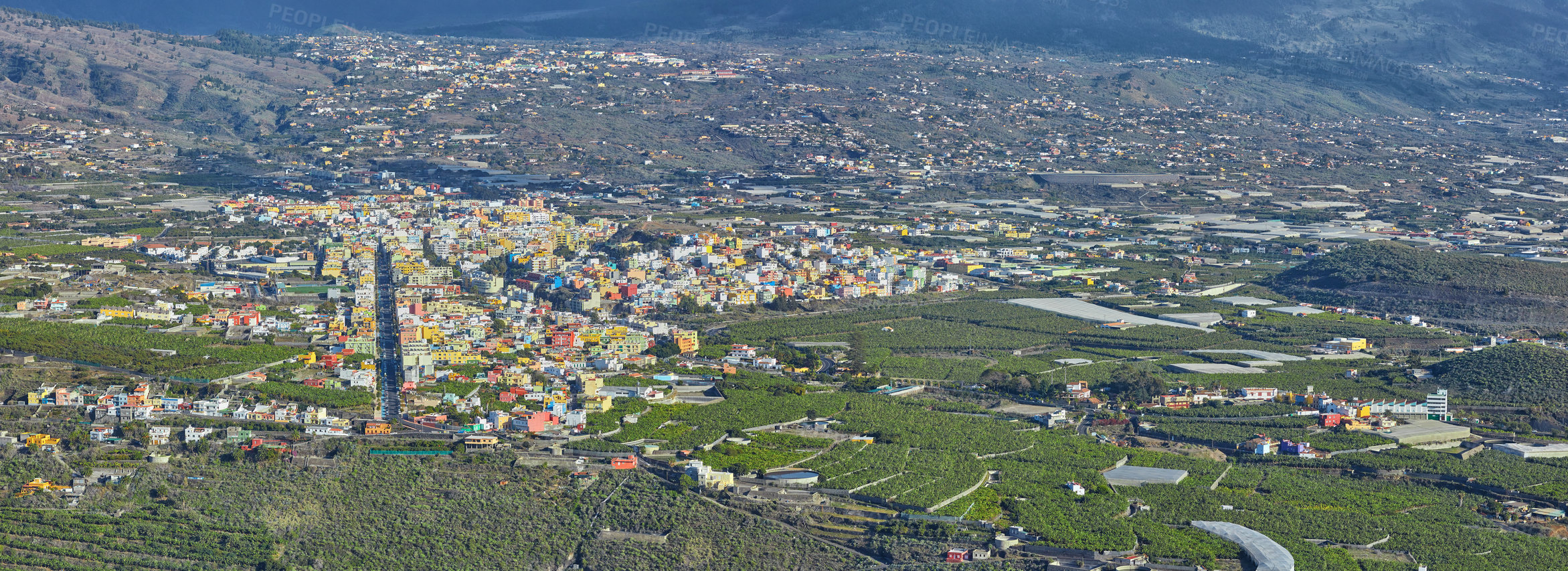 Buy stock photo Aerial landscape view of fruit plantations outside the city of La Palma, Spain. Tropical scenic hills, farming, infrastructure and architecture buildings. Travel abroad to tourism destination