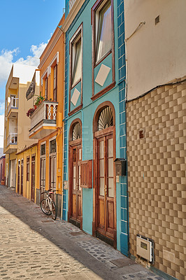 Buy stock photo Scenic view of old historic houses, residential buildings, and traditional infrastructure in cobblestone city alleyways, streets, and roads. Tourism abroad and travel to Santa Cruz, La Palma, Spain