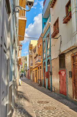 Buy stock photo Colorful historic buildings in vibrant city of Santa Cruz de La Palma with cobblestone alleyway on a sunny day. Bright residential houses in a popular village of a travel and tourism destination