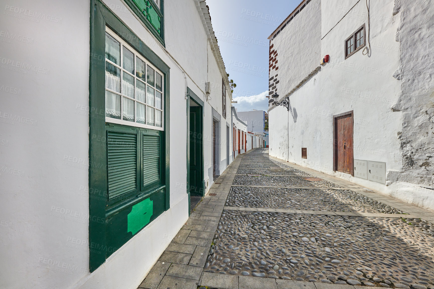 Buy stock photo Scenic view of old historic houses, residential buildings, traditional infrastructure in cobblestone alleyway, street, road. Tourism abroad, overseas travel destination in Santa Cruz, La Palma, Spain