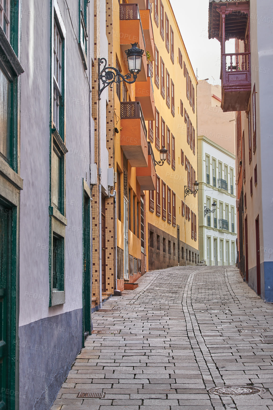 Buy stock photo Scenic street view of old vibrant historic houses, residential buildings and traditional infrastructure in alleyway road. Tourism abroad, overseas travel destination in Santa Cruz de La Palma, Spain