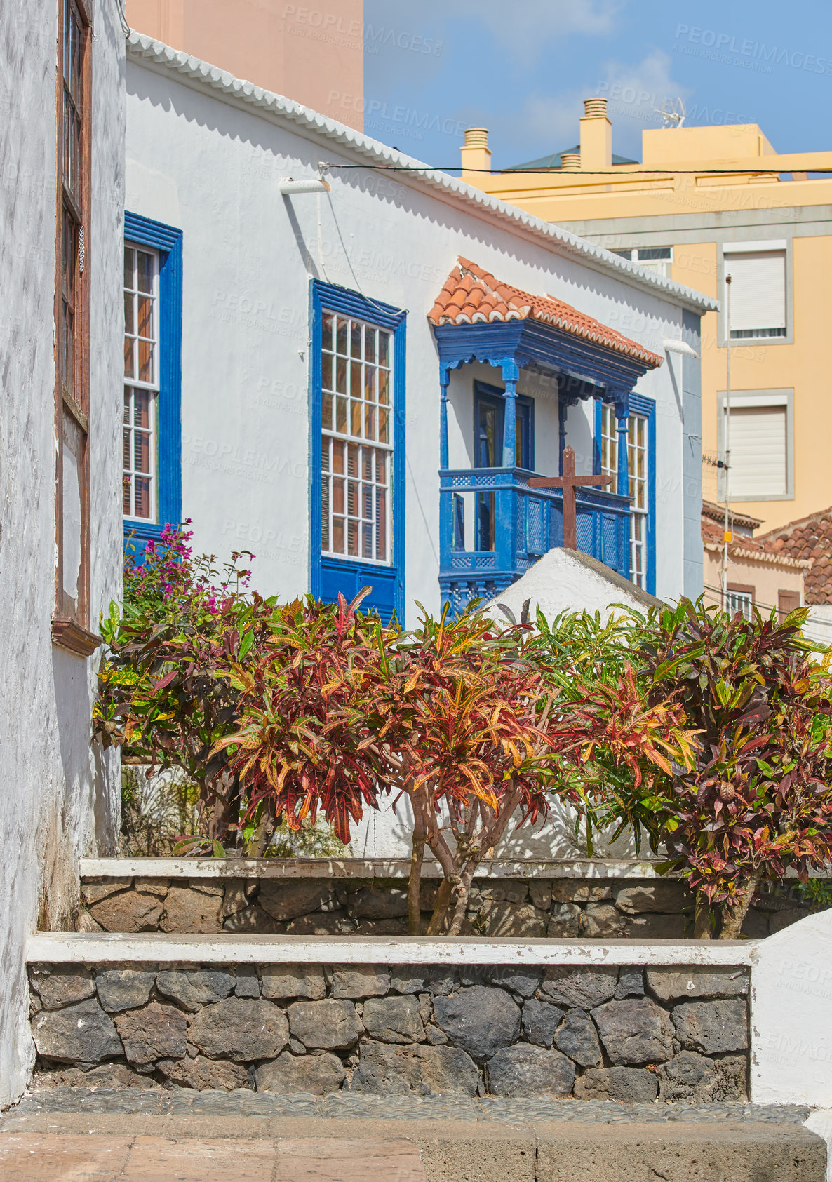 Buy stock photo Traditional architecture of a house exterior in Santa Cruz, La Palma. Facade of an outside residential building structure with decorative plants on a sunny day in the city