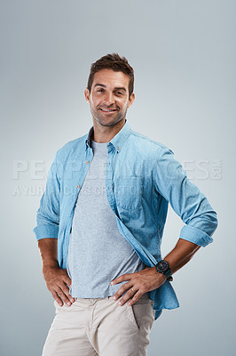 Buy stock photo Portrait, casual and happy man with fashion, smile or trendy outfit for confidence on grey background. Model, positive designer or creative male person with studio, modern clothes or style to relax