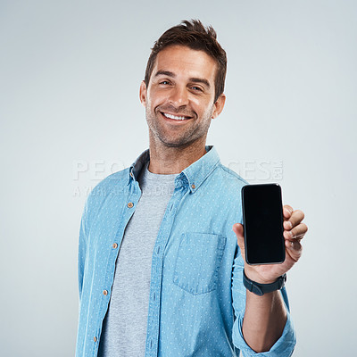 Buy stock photo Advertising, phone screen and portrait with smile of man in studio on white background for communication. App, casual and social media marketing with happy person showing mobile display for mockup