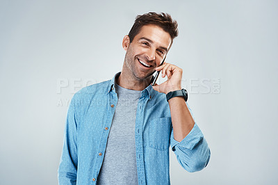 Buy stock photo Phone call, smile and thinking with man in studio on white background for communication or conversation. Contact, funny and laughing with happy person speaking on mobile for chatting or networking