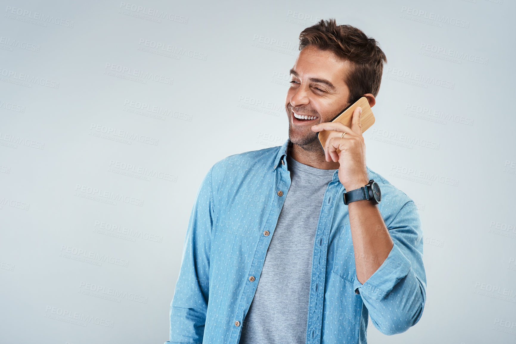 Buy stock photo Phone call, laughing and smile with man in studio on white background for communication or conversation. Contact, funny and thinking with happy person speaking on mobile for chatting or networking