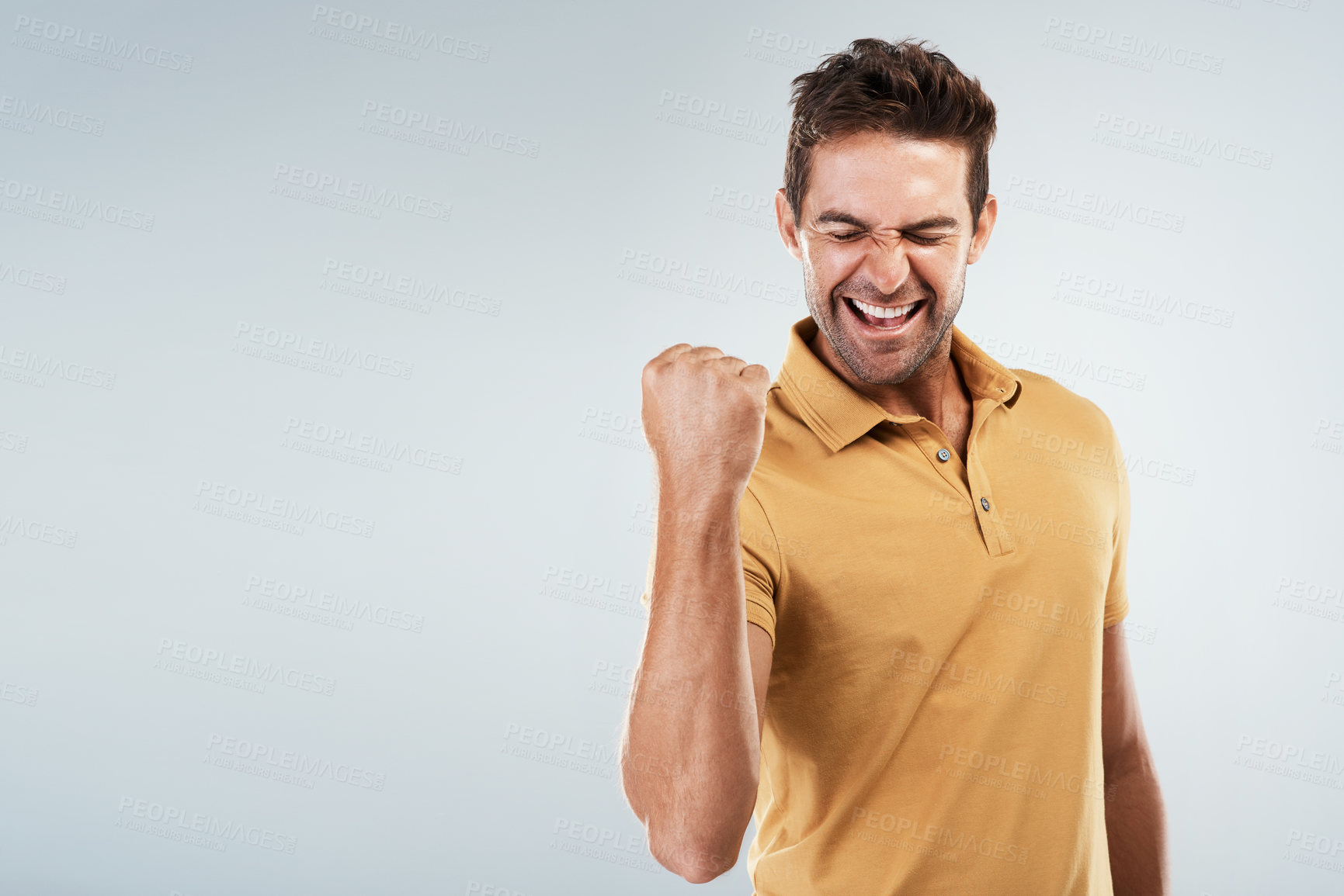 Buy stock photo Celebration, fist pump and winner with smile of man in studio on white background for bonus or success. Achievement, motivation and space with happy model cheering for goal or target on mockup