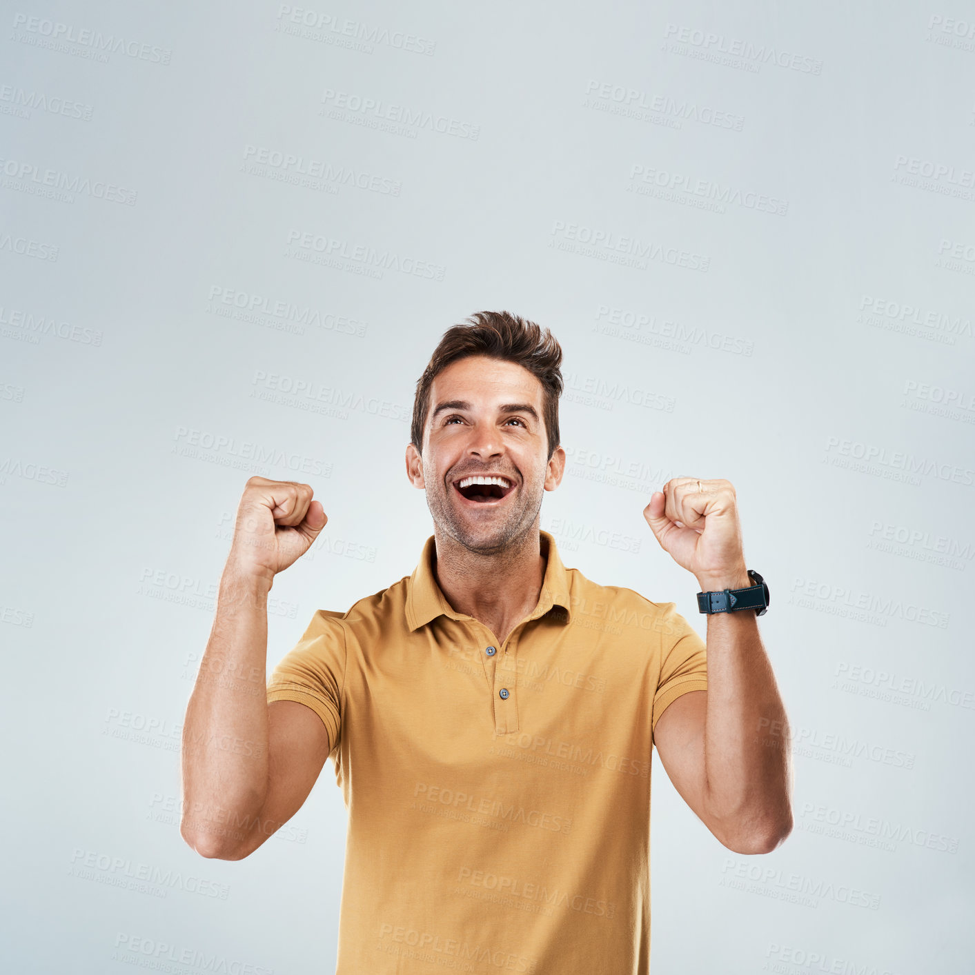 Buy stock photo Celebration, space and winner with fist pump of man in studio on white background for bonus or success. Achievement, mockup and motivation with smile of happy person cheering yes for goal or target