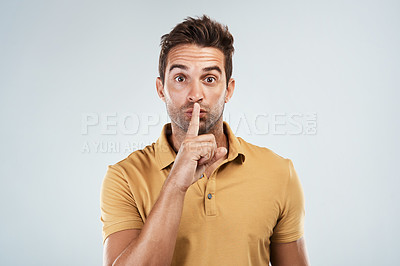 Buy stock photo Man, portrait and finger for mystery in studio, confidential privacy and secret on white background. Male person, shush and emoji for quiet or silence, communication gesture and icon to whisper news