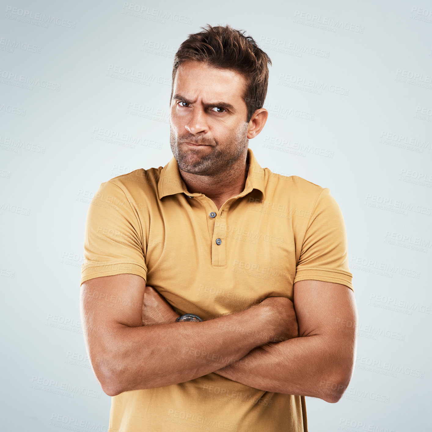 Buy stock photo Man, angry and crossed arms in studio with white background for conflict, fight and attitude problem. Male person, portrait and annoyed on backdrop with upset, unhappy and frustrated body language