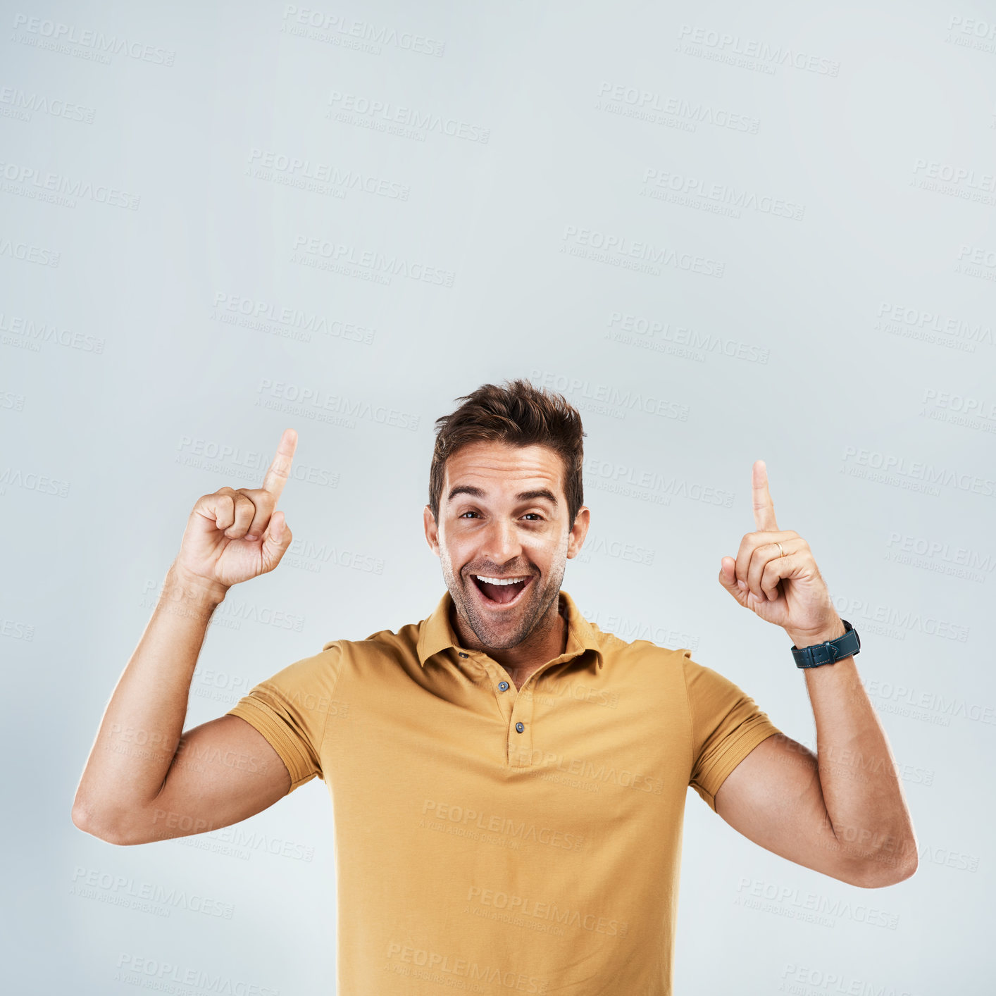 Buy stock photo Shocked, mockup and man pointing for promotion or deal isolated on a gray studio background. Smile, hand gesture and happy guy in portrait and advertising, marketing offer and approve of copy space