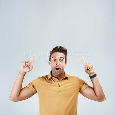 Buy stock photo Excited, mockup and man pointing for promotion or deal isolated on a gray studio background. Smile, hand gesture and happy person advertising, marketing offer and approve of commercial copy space