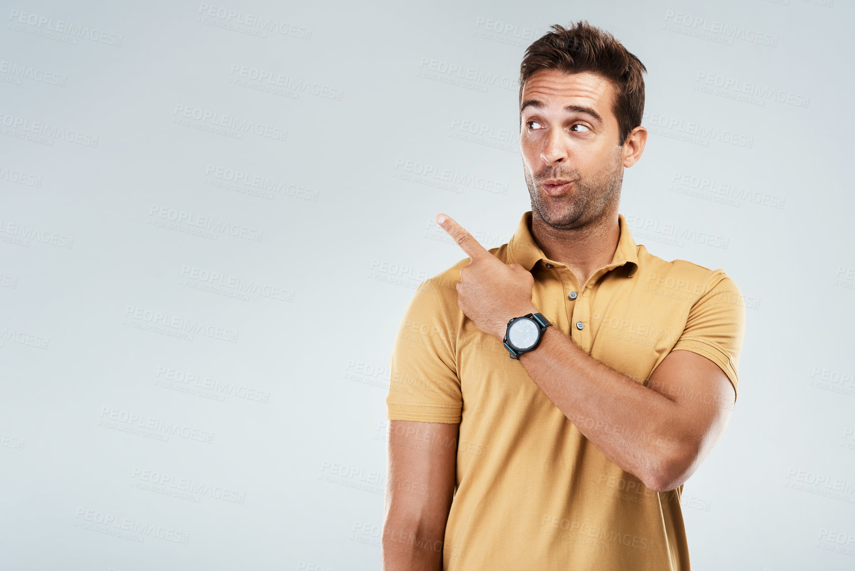 Buy stock photo Man, pointing and secret on studio mockup for reveal, promotion and coming soon. Male promoter, deal and hand gesture on gray background space for announcement, information and quirky for opportunity