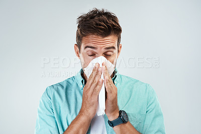 Buy stock photo Sick, tissue and face of man blowing nose in studio with flu, illness and virus on white background. Health, wellness and male person with handkerchief for hay fever, cold and sneeze for allergy