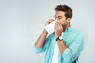 Buy stock photo Allergy, sick and man blowing nose in tissue with flu, illness and virus on studio background. Health mockup, wellness and face of male person with handkerchief for hayfever sinus, cold and sneeze