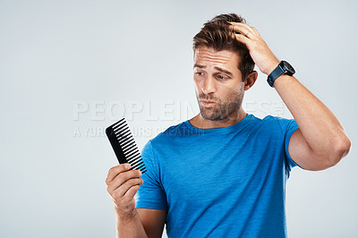 Buy stock photo Man, comb and stress for hair loss in studio with crisis, genetic disease and thyroid problem. Male person, worry and fear for alopecia with brush, testosterone issue and aging by white background