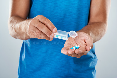 Buy stock photo Man, hands and pills bottle in studio for healthcare, capsule and supplement on gray background. Male person, medicine jar and antibiotics for treatment or omega vitamin, drugs container and dose