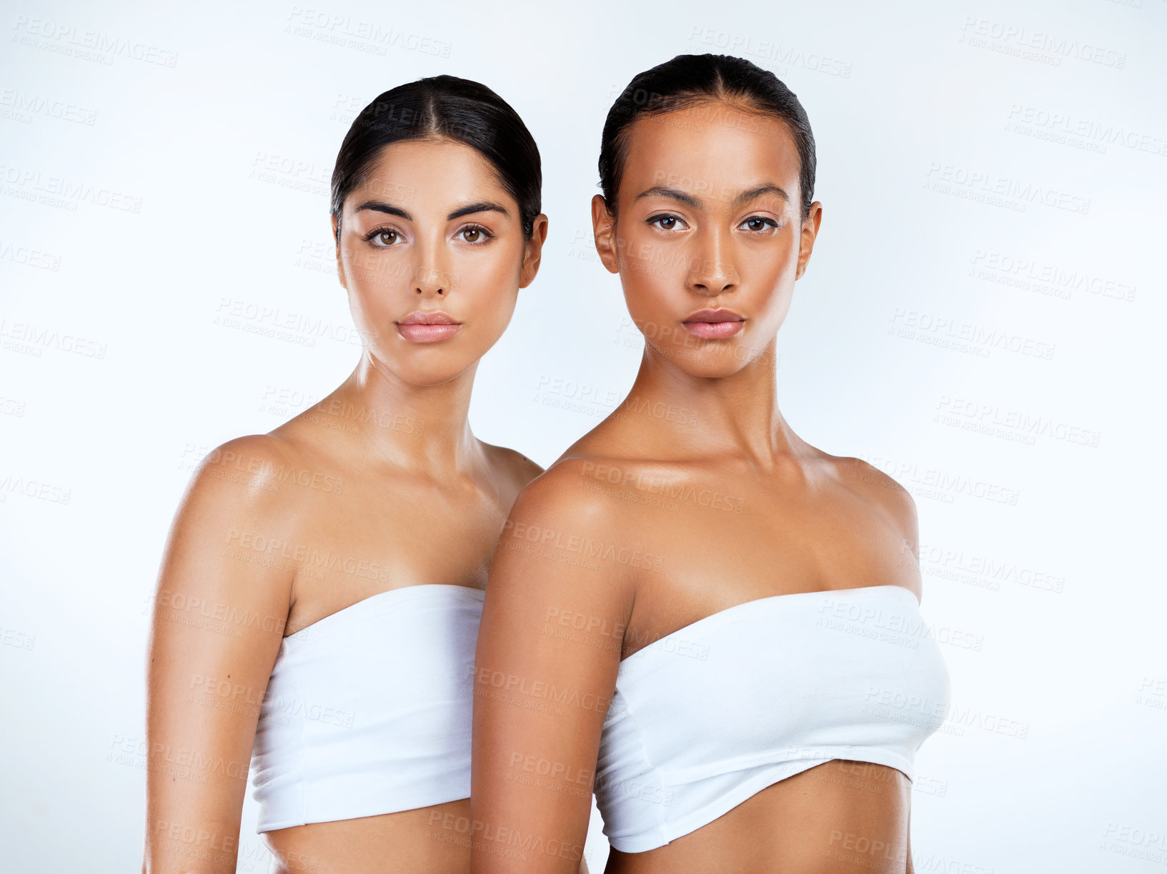 Buy stock photo Studio shot of beautiful young women posing against a grey background 