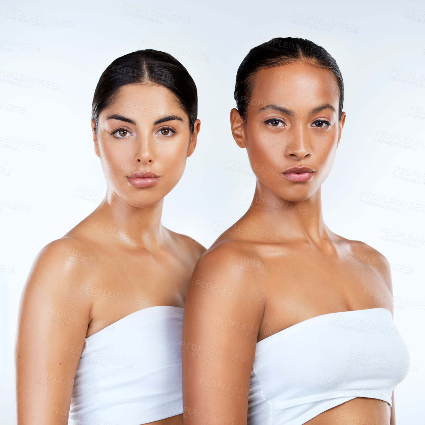 Buy stock photo Studio shot of beautiful young women posing against a grey background 