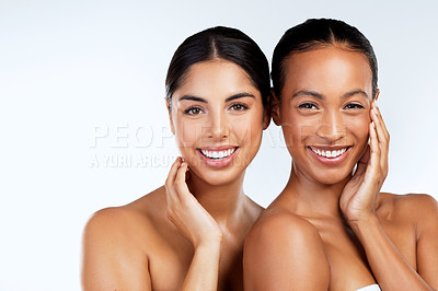 Buy stock photo Studio shot of beautiful young women posing against a grey background 