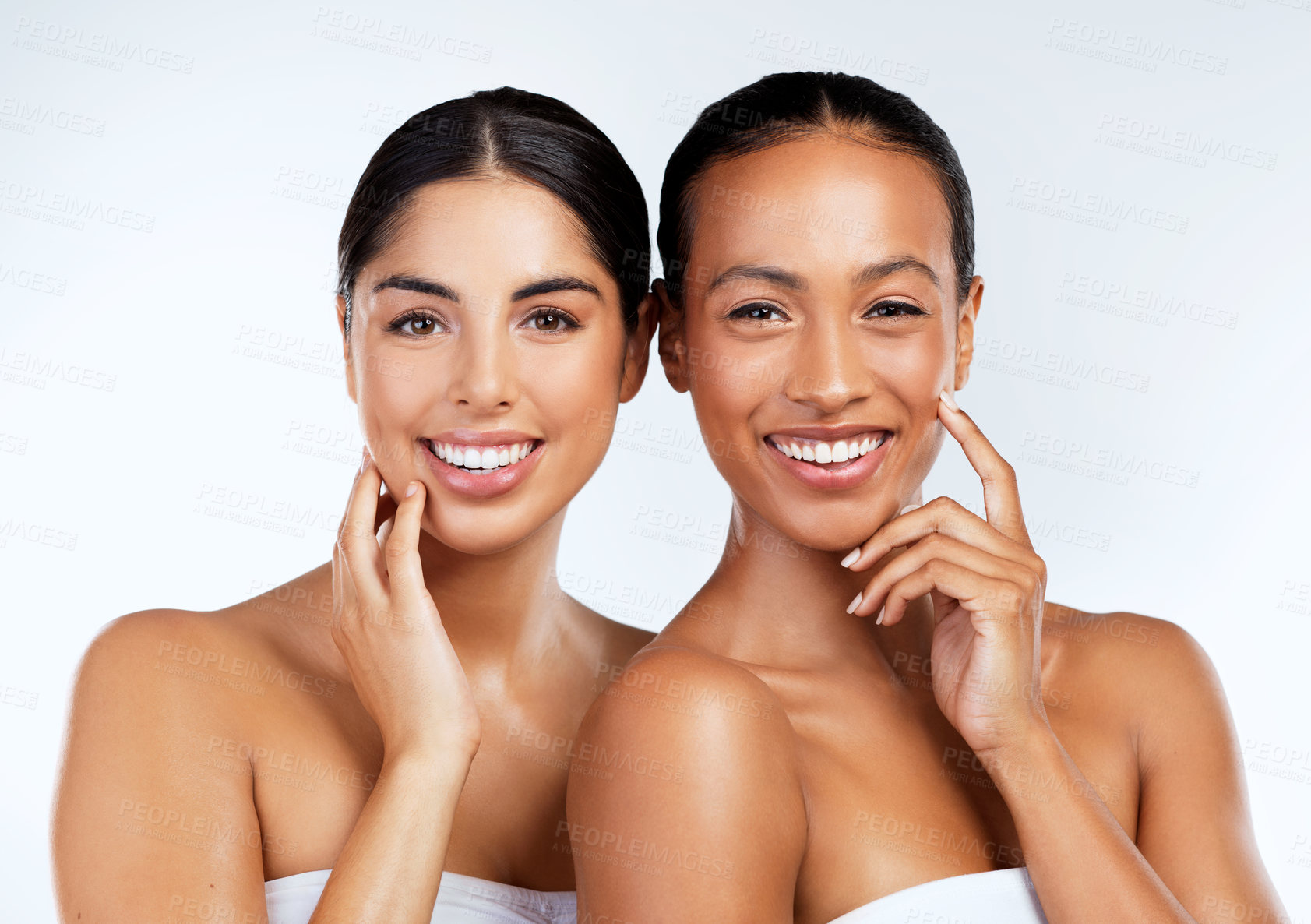 Buy stock photo Studio shot of beautiful young women posing against a grey background 