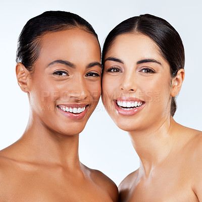 Buy stock photo Studio shot of beautiful young women posing against a grey background 