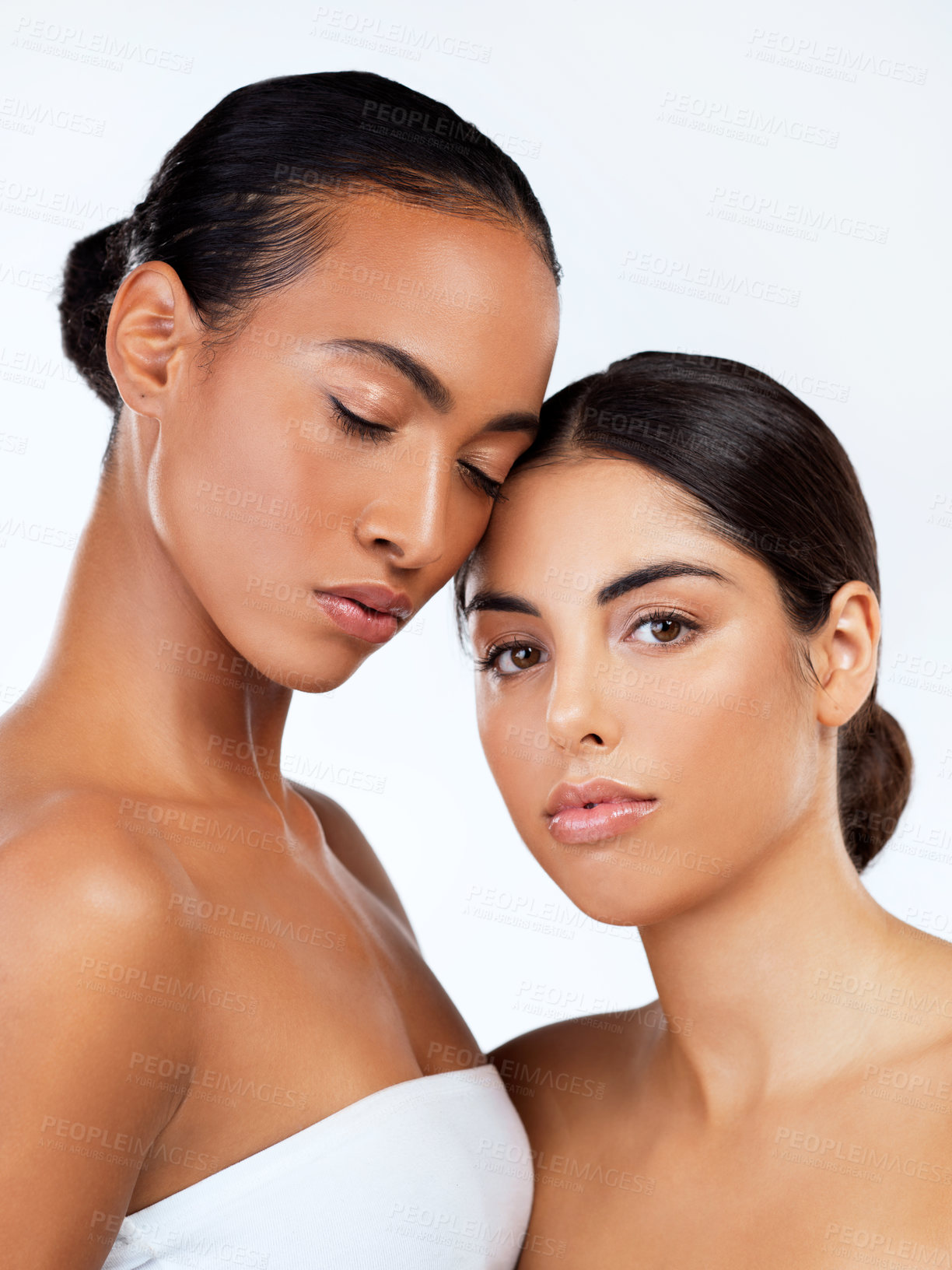 Buy stock photo Studio shot of beautiful young women posing against a grey background 