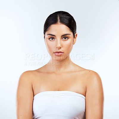 Buy stock photo Studio, skincare and beauty of woman, glow and smooth with treatment of skin, anti aging and portrait. Blue background, confident and shine of face with cosmetics, serious and model with wellness