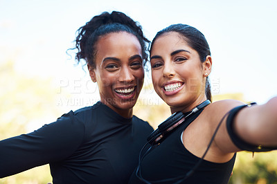 Buy stock photo Cropped portrait of two attractive young women posing for a selfie after their run together in the park