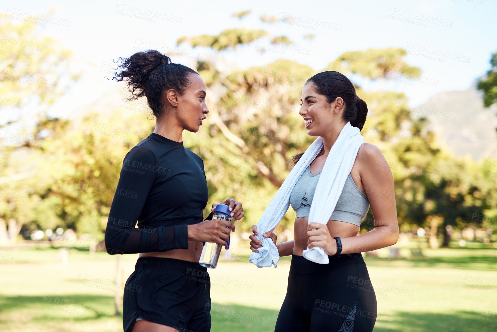 Buy stock photo Break, fitness and talking with woman friends outdoor in park together for conversation or performance. Exercise, health and smile with happy athlete people speaking in nature for training challenge