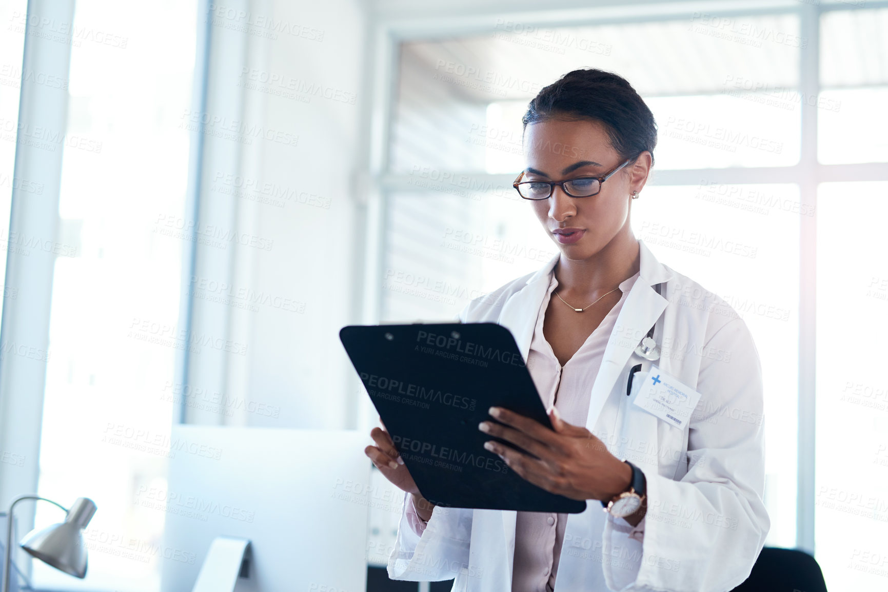 Buy stock photo Woman, doctor and reading with clipboard for medical results, information or research at hospital. Female person or healthcare employee checking paperwork, documents or health forms for procedure