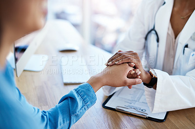 Buy stock photo Cropped shot of a doctor holding hands with a patient in her consulting room