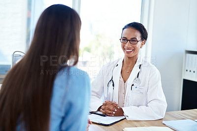 Buy stock photo Shot of a young doctor having a discussion with a patient in her consulting room